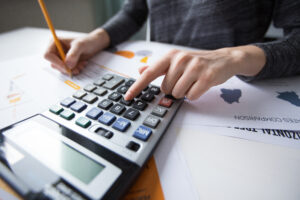 close up female hand counting with calculator