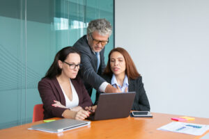 group top managers watching discussing project presentation laptop male executive pointing display while female managers explaining details